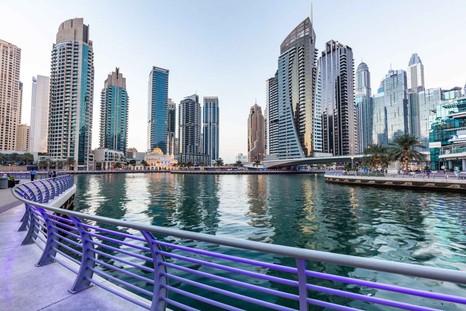 Dubai marina promenade in UAE at sunset. Highrise residential buildings, business skyscrapers
